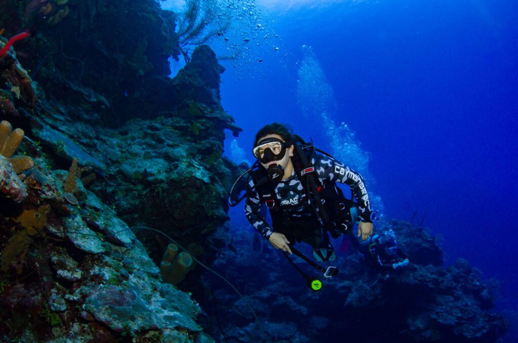 Scuba diver along a reef wall in Grand Cayman with Tortuga Divers of Red Sail Sports