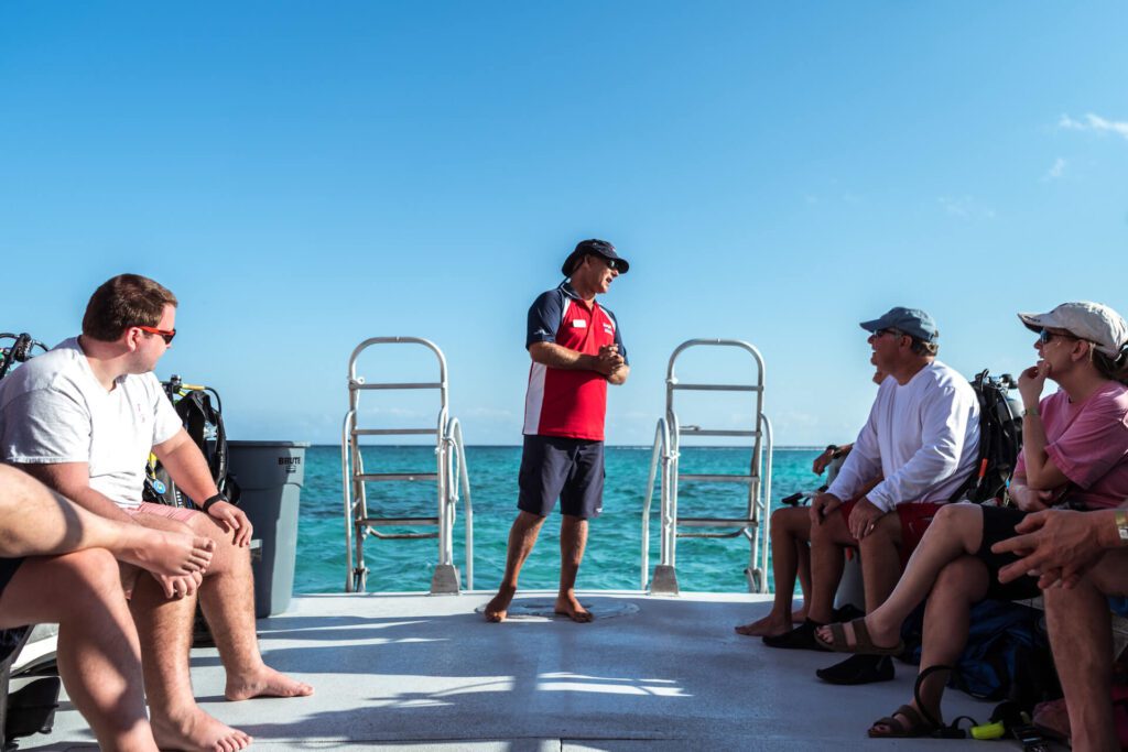 Instructor talking to divers on a boat