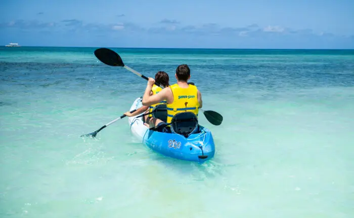 A man and a woman on a kayak in the ocean